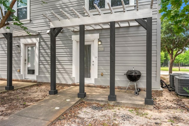 1725 Harvey Mitchell Pkwy, College Station, TX 77840 - entrance to property featuring a pergola and central AC unit
