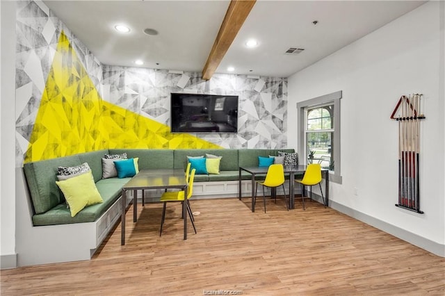 1725 Harvey Mitchell Pkwy, College Station, TX 77840 - living area featuring an accent wall, wood finished floors, recessed lighting, beamed ceiling, and baseboards