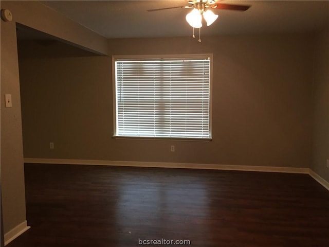 spare room featuring ceiling fan and dark hardwood / wood-style flooring