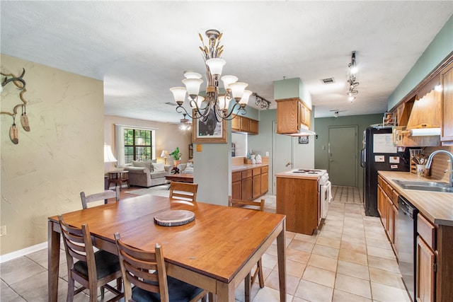 9777 Deer Trail Run, Hearne, TX 77859 - dining area featuring light tile patterned flooring, a chandelier, and rail lighting