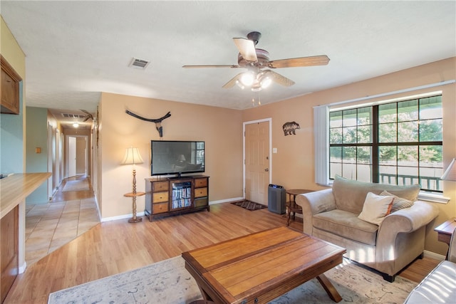 9777 Deer Trail Run, Hearne, TX 77859 - living area with light wood-type flooring and ceiling fan