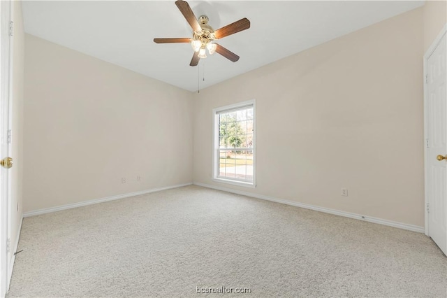 empty room with carpet, ceiling fan, and baseboards