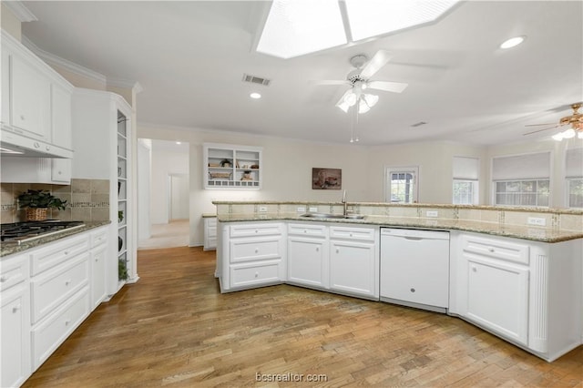 kitchen featuring visible vents, ceiling fan, white dishwasher, stainless steel gas stovetop, and a sink