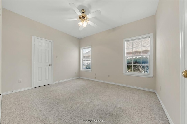 spare room with baseboards, a ceiling fan, and carpet flooring