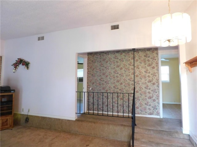 empty room with a notable chandelier