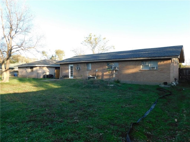 back of house with a lawn