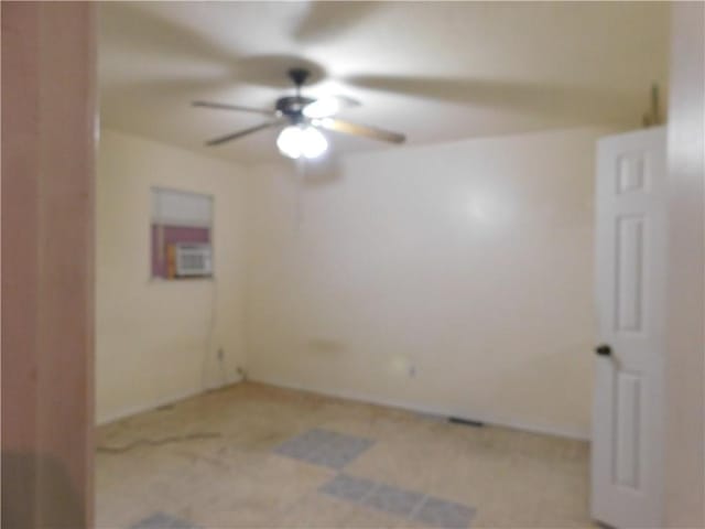 spare room with light colored carpet and ceiling fan