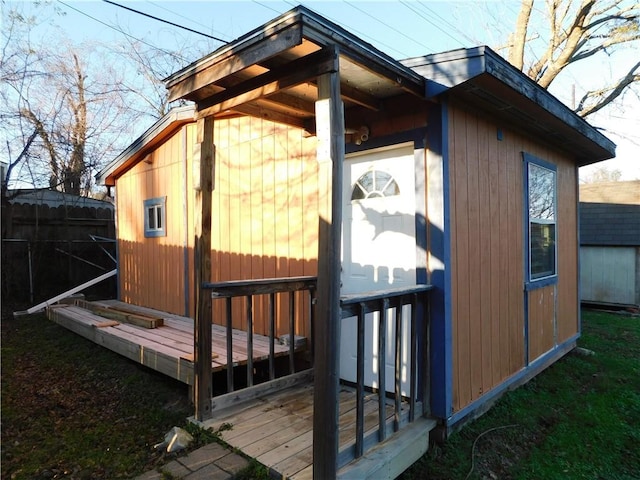 view of home's exterior featuring a deck and an outdoor structure