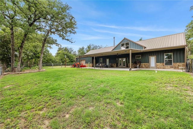 3205 County Road 308, Caldwell, TX 77836 - back of property with board and batten siding, french doors, a patio, and metal roof