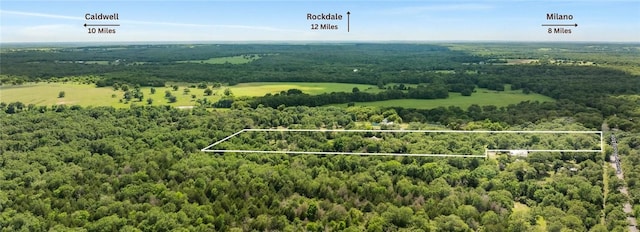 3205 County Road 308, Caldwell, TX 77836 - aerial view of property and surrounding area with a heavily wooded area and property parcel outlined