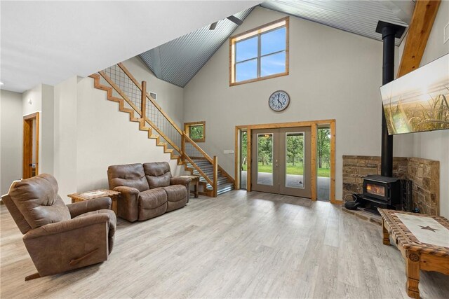 3205 County Road 308, Caldwell, TX 77836 - living room with a wood stove, stairs, wood finished floors, high vaulted ceiling, and french doors