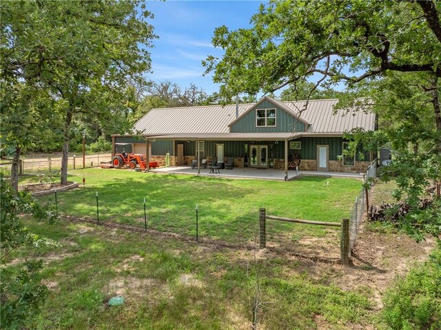 3205 County Road 308, Caldwell, TX 77836 - rear view of house featuring board and batten siding, a patio area, and french doors