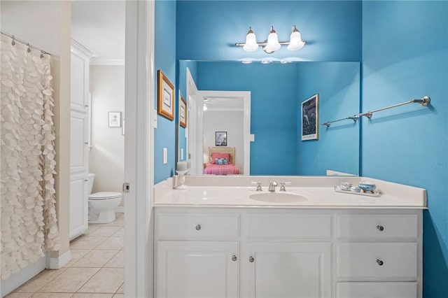 bathroom with vanity, tile patterned flooring, and toilet