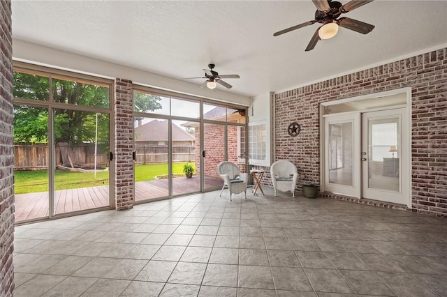 sunroom / solarium with a ceiling fan