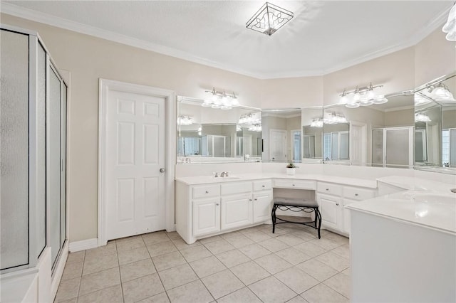 full bathroom with crown molding, vanity, tile patterned flooring, and a shower stall