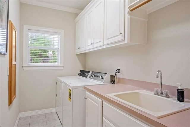 laundry area featuring light tile patterned flooring, washer and dryer, baseboards, a sink, and cabinet space