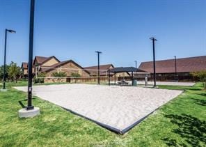128 Kimber Ln, College Station, TX 77845 - surrounding community with volleyball court and a lawn