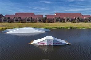 128 Kimber Ln, College Station, TX 77845 - view of parking featuring a water view
