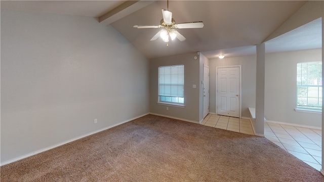 spare room featuring ceiling fan, light colored carpet, and lofted ceiling with beams