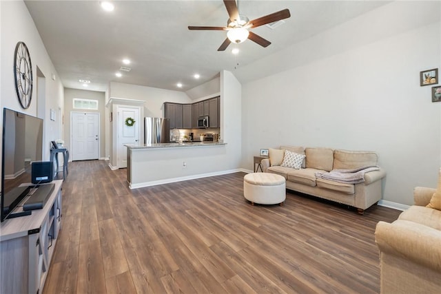 living area with baseboards, lofted ceiling, dark wood-style floors, ceiling fan, and recessed lighting