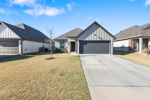 modern farmhouse with a garage, driveway, board and batten siding, and a front yard