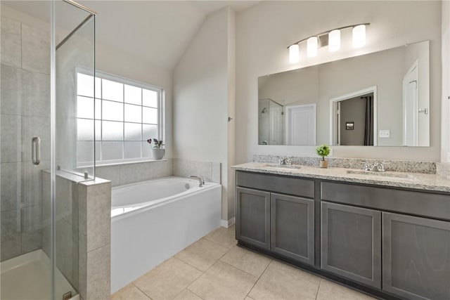 bathroom with lofted ceiling, a sink, a shower stall, tile patterned flooring, and a bath