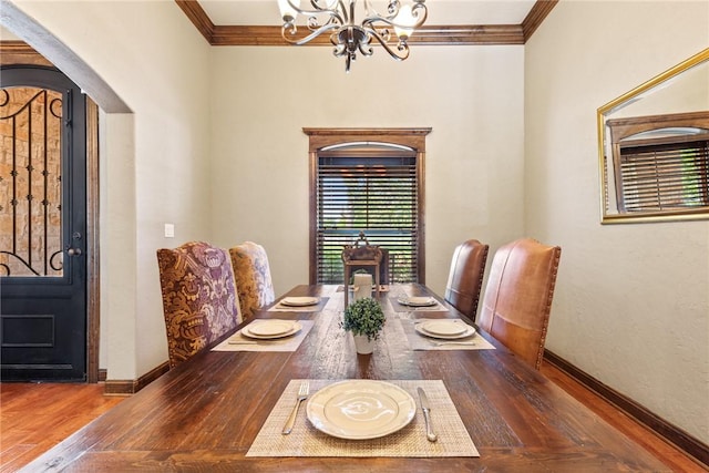 18265 Windmill Ct, College Station, TX 77845 - dining room with a chandelier, crown molding, wood finished floors, and arched walkways