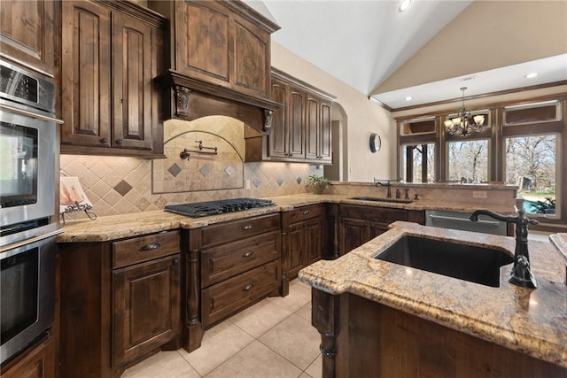 kitchen featuring a sink, double oven, black gas stovetop, and lofted ceiling