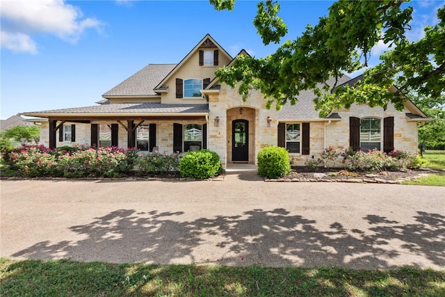 18265 Windmill Ct, College Station, TX 77845 - view of front facade featuring stone siding and roof with shingles