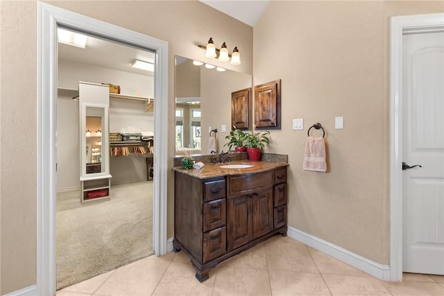 bathroom featuring baseboards, vanity, and tile patterned floors