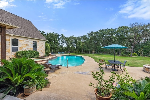 18265 Windmill Ct, College Station, TX 77845 - view of swimming pool with a yard, a patio area, view of wooded area, and a pool with connected hot tub
