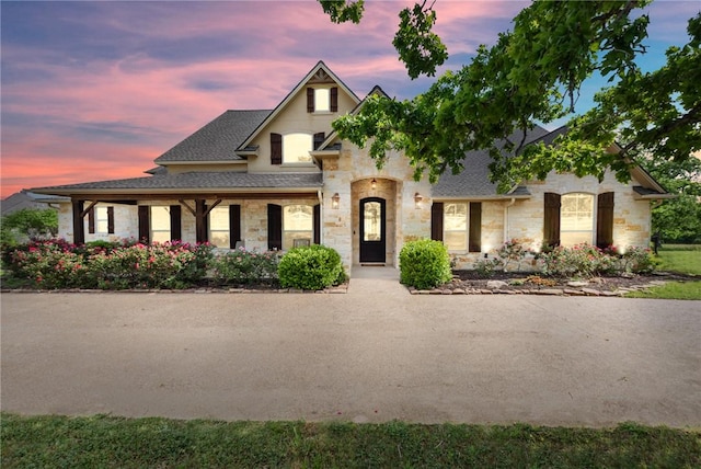 18265 Windmill Ct, College Station, TX 77845 - french country style house with stone siding and a shingled roof