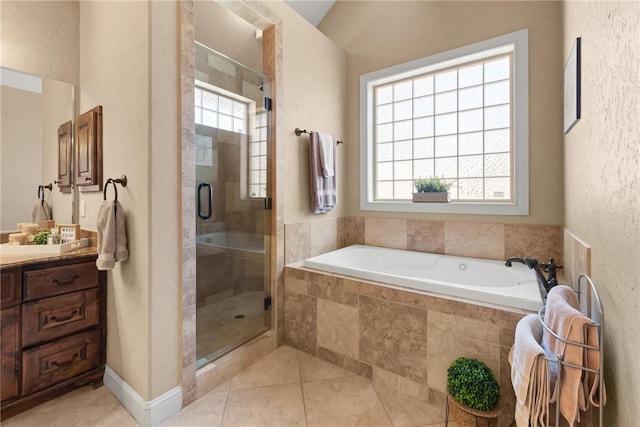 full bathroom featuring a bath, a shower stall, tile patterned flooring, and vanity