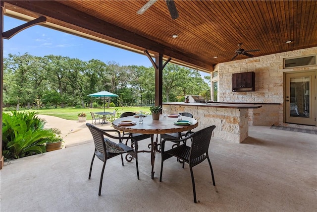 18265 Windmill Ct, College Station, TX 77845 - view of patio / terrace featuring a ceiling fan, area for grilling, outdoor dining space, and view of scattered trees