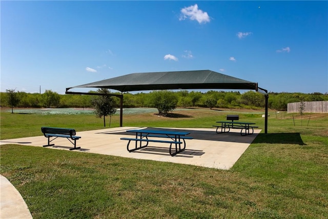 view of community with a water view, a gazebo, a patio, and a yard