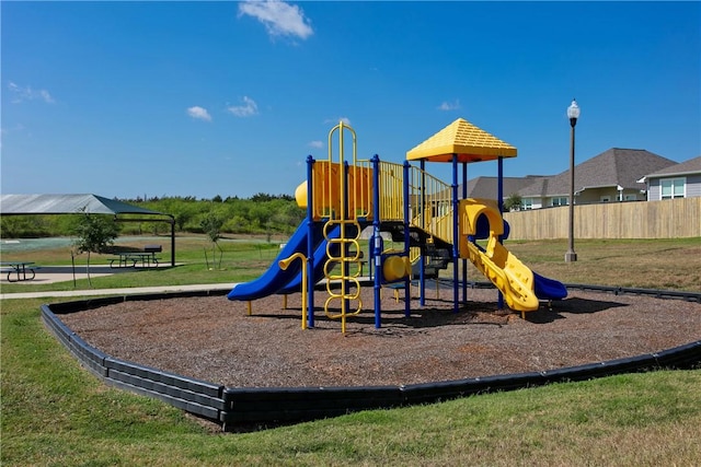 community playground with fence and a lawn