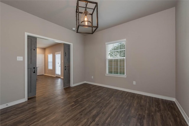 empty room with dark wood-type flooring