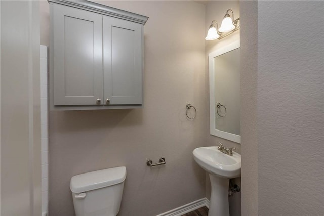 bathroom featuring toilet and sink