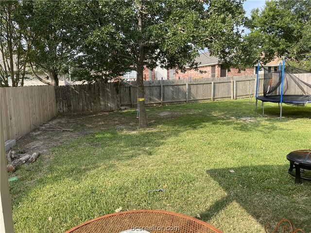 view of yard with a trampoline