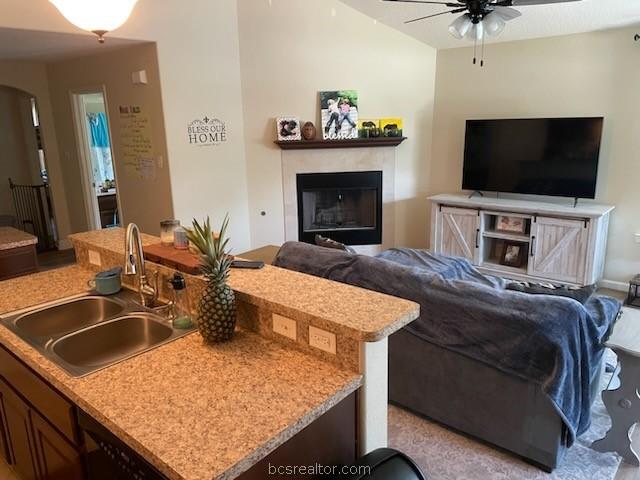 living room featuring ceiling fan and sink