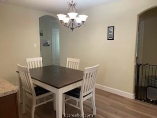 dining room with a chandelier and hardwood / wood-style flooring