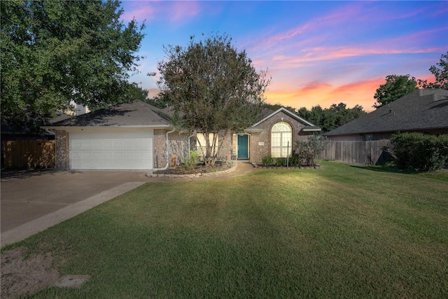 view of front of property with a yard and a garage