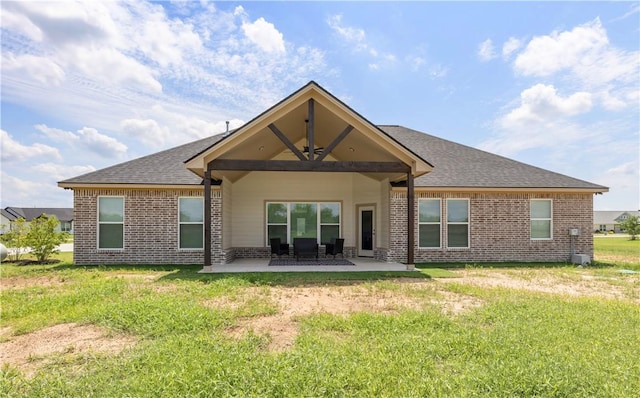 3310 Hunters Crossing Trl, Bryan, TX 77808 - back of house featuring brick siding, a patio, and a lawn