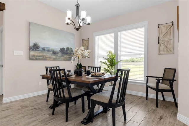 3310 Hunters Crossing Trl, Bryan, TX 77808 - dining room featuring a chandelier, baseboards, and light wood-type flooring