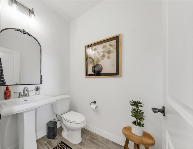 3310 Hunters Crossing Trl, Bryan, TX 77808 - half bath featuring baseboards, toilet, and wood finished floors