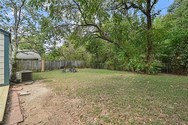 view of yard with cooling unit and a fenced backyard