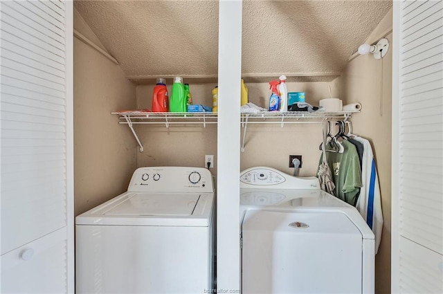 clothes washing area with laundry area, independent washer and dryer, and a textured ceiling