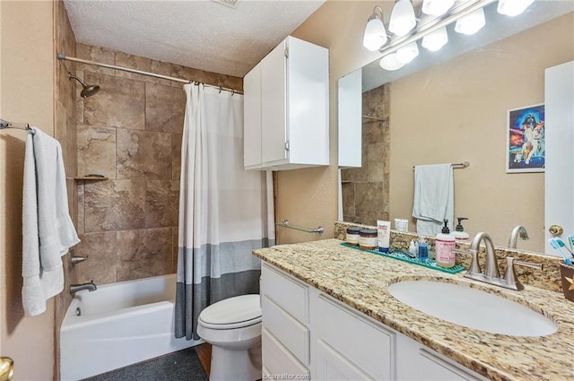 bathroom with vanity, shower / tub combo, toilet, and a textured ceiling