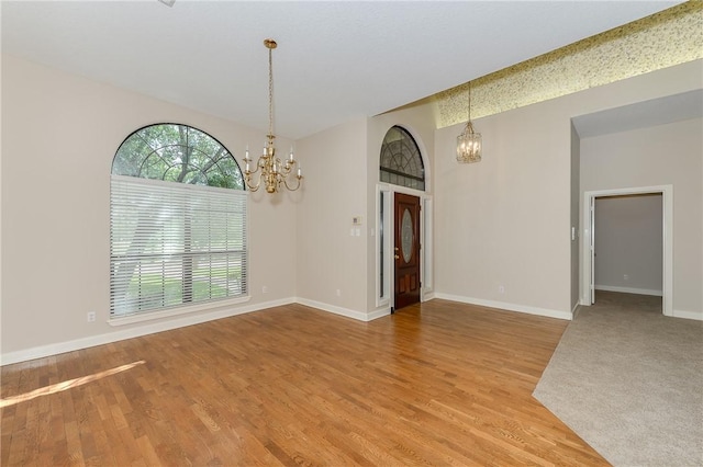 9300 Lakeside Ct, College Station, TX 77845 - spare room with a chandelier, light wood-style floors, and baseboards