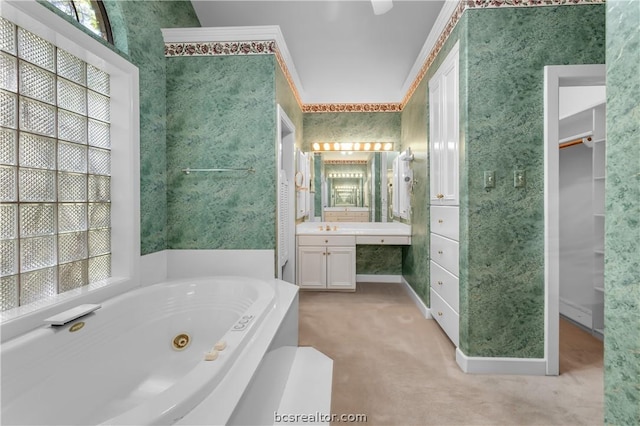 bathroom with vanity, a bathtub, and crown molding